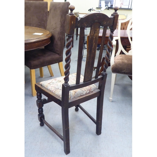 305 - Mainly early 20thC oak chairs: to include one with barleytwist uprights and a drop-in seat