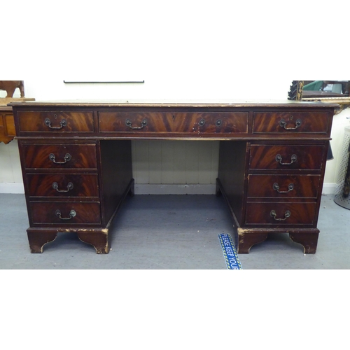 309 - A modern mahogany nine drawer twin pedestal desk, raised on bracket feet&nbsp; 30
