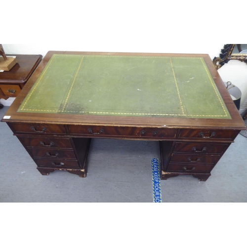 309 - A modern mahogany nine drawer twin pedestal desk, raised on bracket feet&nbsp; 30