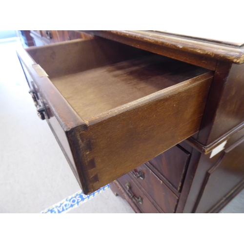 309 - A modern mahogany nine drawer twin pedestal desk, raised on bracket feet&nbsp; 30