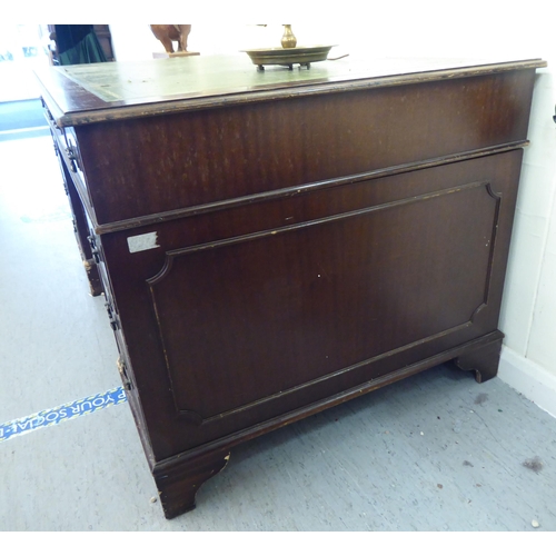 309 - A modern mahogany nine drawer twin pedestal desk, raised on bracket feet&nbsp; 30