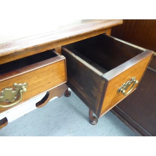 310 - A late 19thC walnut and mahogany three drawer lowboy, raised on tapered legs and pad feet&nbsp; 29