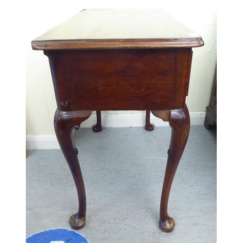 310 - A late 19thC walnut and mahogany three drawer lowboy, raised on tapered legs and pad feet&nbsp; 29