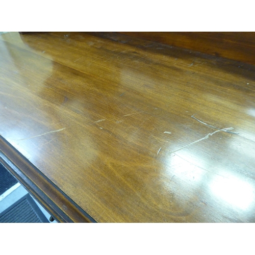 311 - An Edwardian mahogany dresser, the superstructure with a mirrored panel, two open shelves, over two ... 