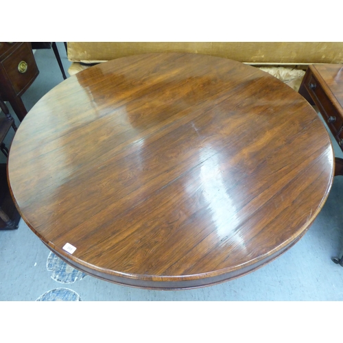 313 - A William IV rosewood pedestal centre table, on a bulbous column, a circular plinth and lion paw fee... 