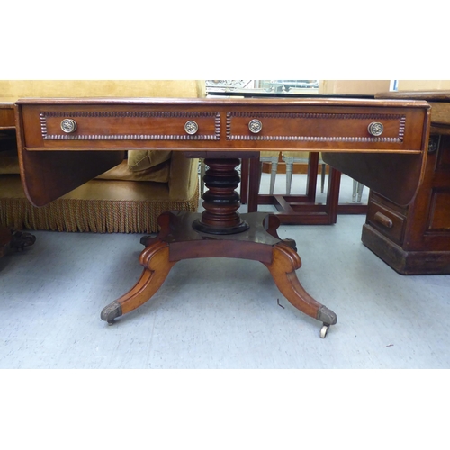 314 - A Victorian crossbanded rosewood and mahogany sofa table with two pairs of frieze drawers, raised on... 
