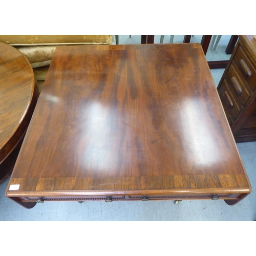 314 - A Victorian crossbanded rosewood and mahogany sofa table with two pairs of frieze drawers, raised on... 