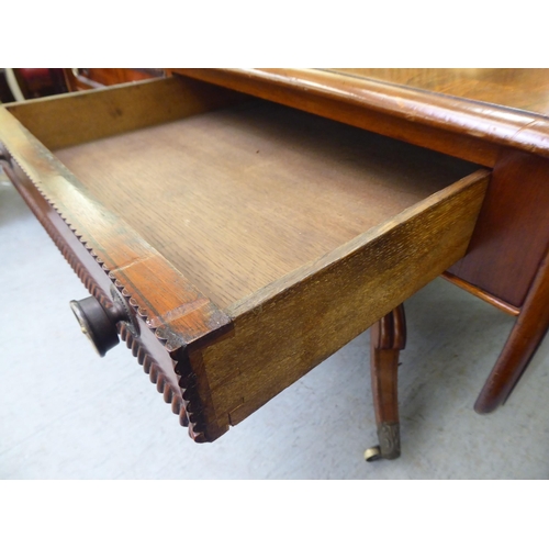 314 - A Victorian crossbanded rosewood and mahogany sofa table with two pairs of frieze drawers, raised on... 
