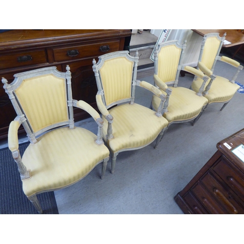 315 - A set of four mid 20thC French inspired shabby chic showwood framed open arm salon chairs with two t... 
