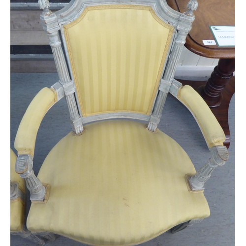 315 - A set of four mid 20thC French inspired shabby chic showwood framed open arm salon chairs with two t... 