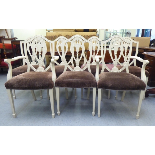 317 - A set of seven Edwardian Sheraton Revival inspired cream coloured painted shield and pierced vase de... 