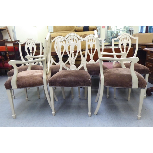 317 - A set of seven Edwardian Sheraton Revival inspired cream coloured painted shield and pierced vase de... 