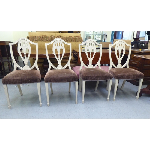 317 - A set of seven Edwardian Sheraton Revival inspired cream coloured painted shield and pierced vase de... 