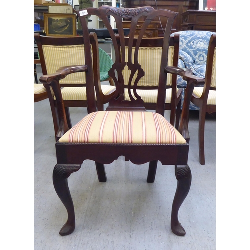 320 - An early 20thC Georgian style mahogany framed open arm chair, raised on cabriole forelegs
