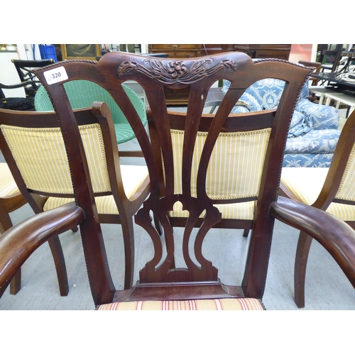 320 - An early 20thC Georgian style mahogany framed open arm chair, raised on cabriole forelegs