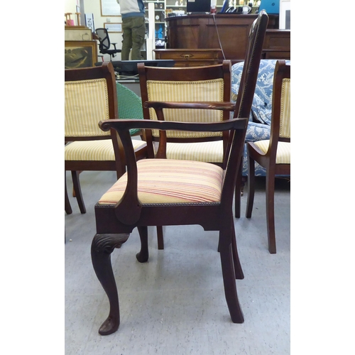 320 - An early 20thC Georgian style mahogany framed open arm chair, raised on cabriole forelegs