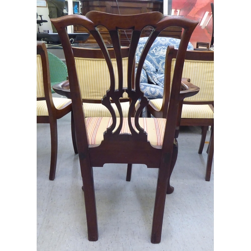 320 - An early 20thC Georgian style mahogany framed open arm chair, raised on cabriole forelegs