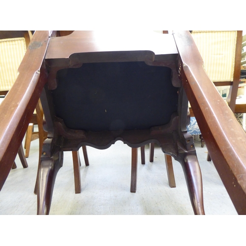 320 - An early 20thC Georgian style mahogany framed open arm chair, raised on cabriole forelegs