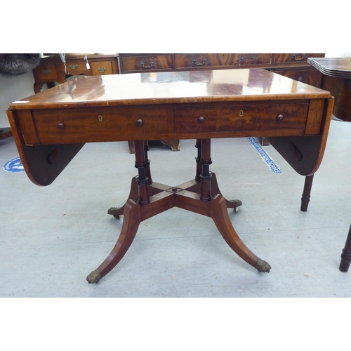 321 - 19thC and later furniture: to include a Regency reproduction of a mahogany sofa table, raised on spl... 