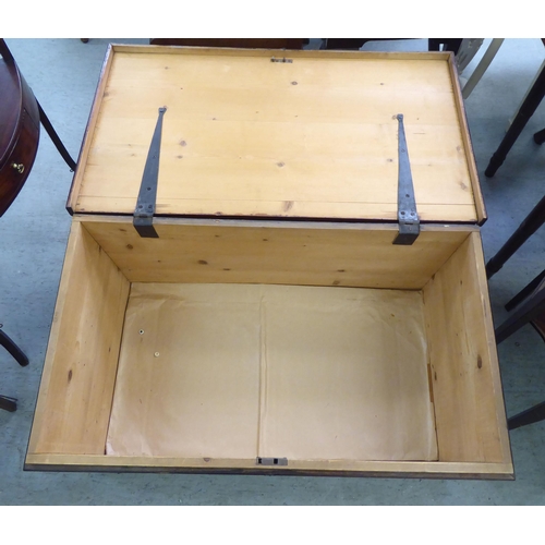 328 - An early 20thC pine chest with straight sides and a hinged lid, on a plinth&nbsp; 17