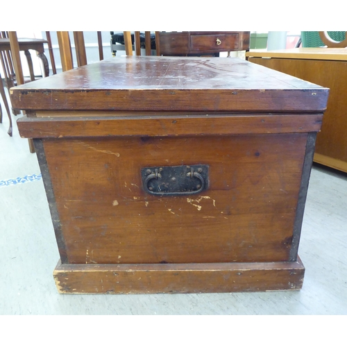 328 - An early 20thC pine chest with straight sides and a hinged lid, on a plinth&nbsp; 17