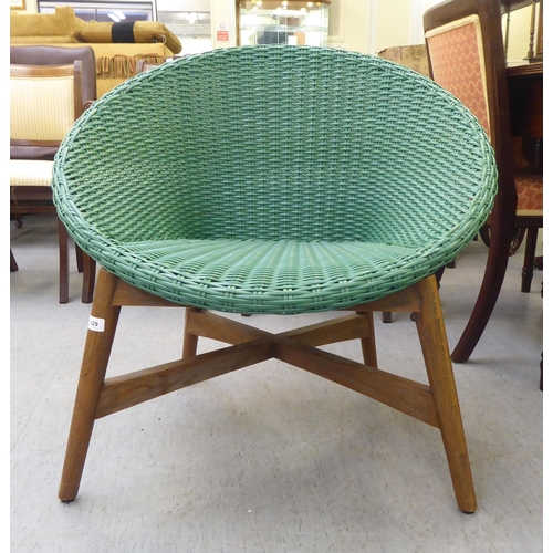 329 - A modern Indonesian made green wicker style easy chair, on a teak underframe