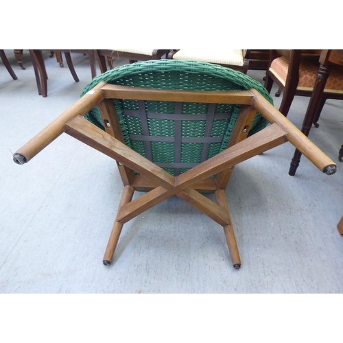 329 - A modern Indonesian made green wicker style easy chair, on a teak underframe