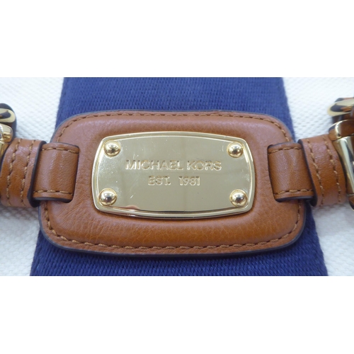 330 - A ladies Michael Kors brown leather, cream coloured and dark blue fabric handbag