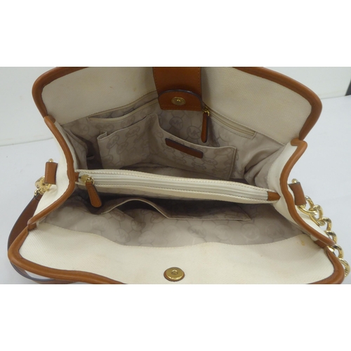 330 - A ladies Michael Kors brown leather, cream coloured and dark blue fabric handbag
