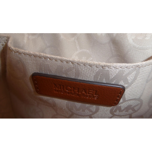330 - A ladies Michael Kors brown leather, cream coloured and dark blue fabric handbag
