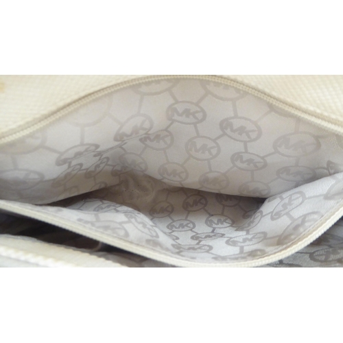 330 - A ladies Michael Kors brown leather, cream coloured and dark blue fabric handbag