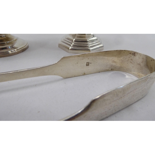 334 - A silver plated caster; another in silver; and a pair of silver sugar tongs  mixed marks