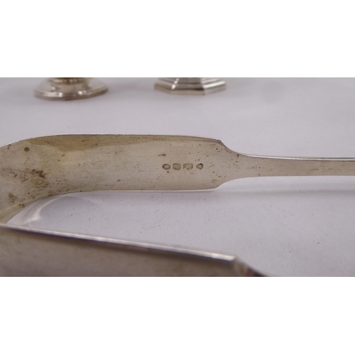 334 - A silver plated caster; another in silver; and a pair of silver sugar tongs  mixed marks
