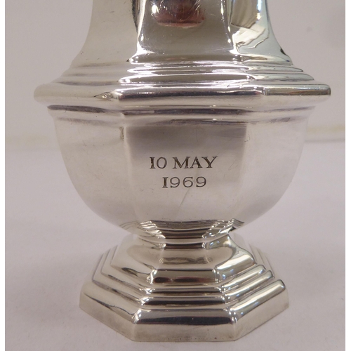 334 - A silver plated caster; another in silver; and a pair of silver sugar tongs  mixed marks