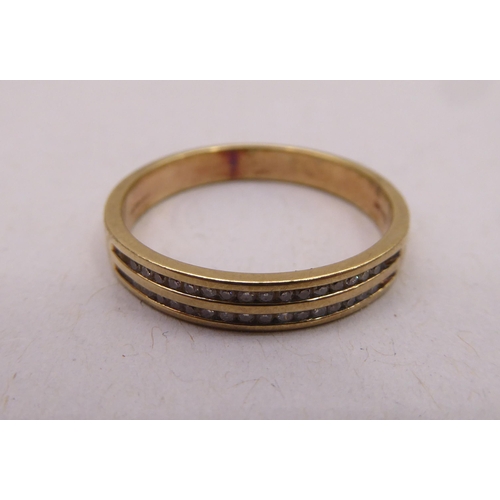 336 - A gold coloured metal ring, set with two rows of diamonds