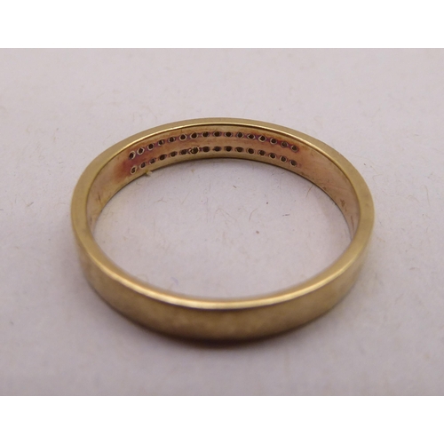 336 - A gold coloured metal ring, set with two rows of diamonds