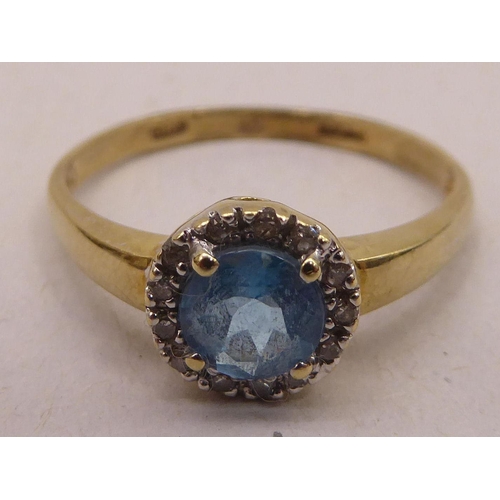 339 - A 9ct gold blue topaz and diamond set cluster ring