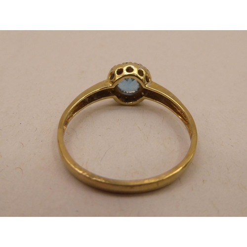 339 - A 9ct gold blue topaz and diamond set cluster ring