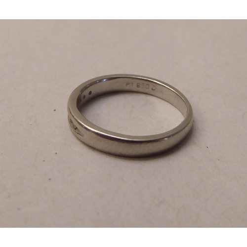 341 - A platinum band ring, set with seven small diamonds