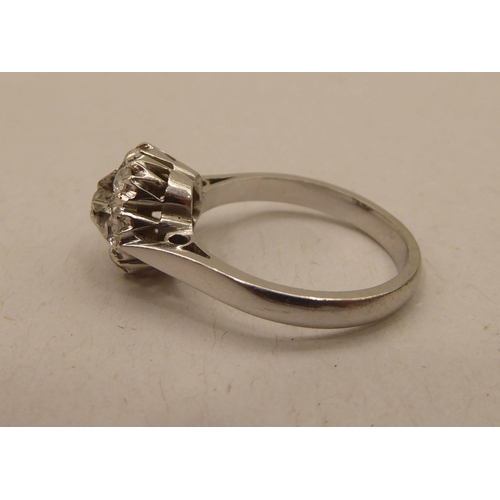 343 - A white metal seven diamond set, floral design cluster ring