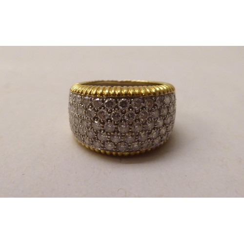 344 - An 18ct bi-coloured diamond pave set band ring