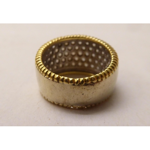 344 - An 18ct bi-coloured diamond pave set band ring