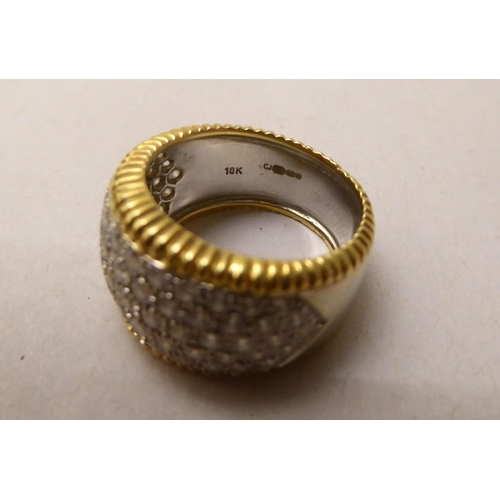 344 - An 18ct bi-coloured diamond pave set band ring