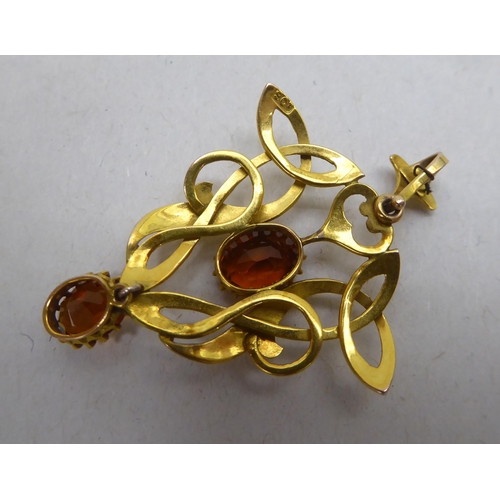 347 - A 9ct gold Art Nouveau inspired pendant, set with two citrines