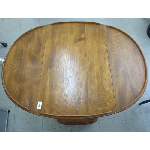 348 - An Ercol light elm, two tier tea trolley with fall flaps, raised on casters&nbsp; 30