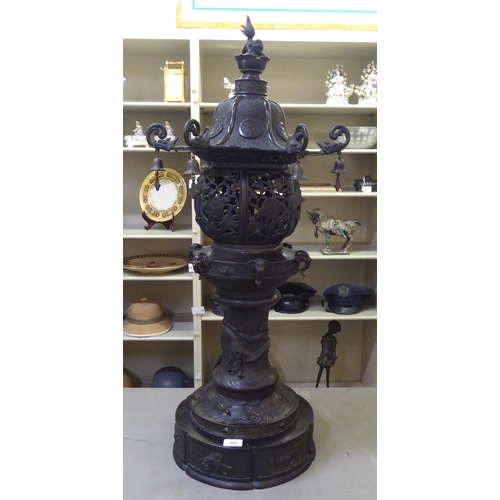 351 - A Japanese bronze finished, metal temple censer with a pagoda top, over a pierced bowl, on a pedesta... 