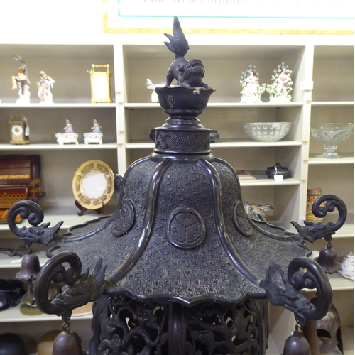 351 - A Japanese bronze finished, metal temple censer with a pagoda top, over a pierced bowl, on a pedesta... 