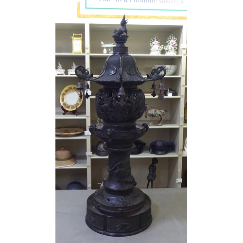 351 - A Japanese bronze finished, metal temple censer with a pagoda top, over a pierced bowl, on a pedesta... 