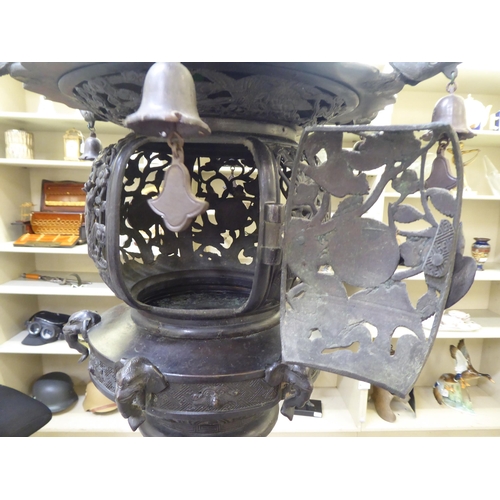 351 - A Japanese bronze finished, metal temple censer with a pagoda top, over a pierced bowl, on a pedesta... 