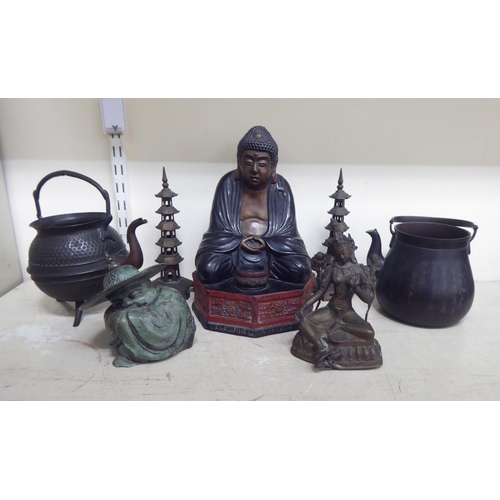 356 - Oriental collectables: to include a pair of bronze finished metal stupas  9